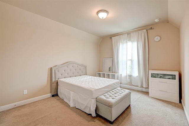 bedroom with carpet floors and lofted ceiling