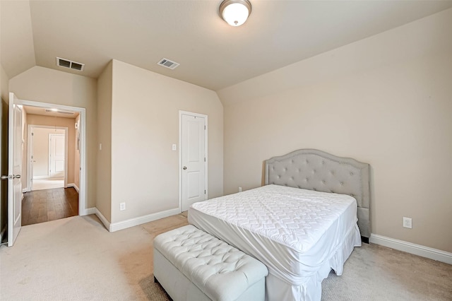 carpeted bedroom featuring vaulted ceiling