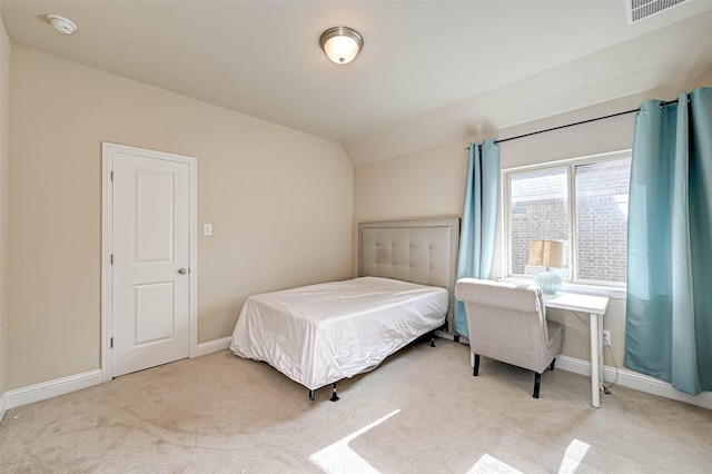 bedroom with carpet flooring and lofted ceiling