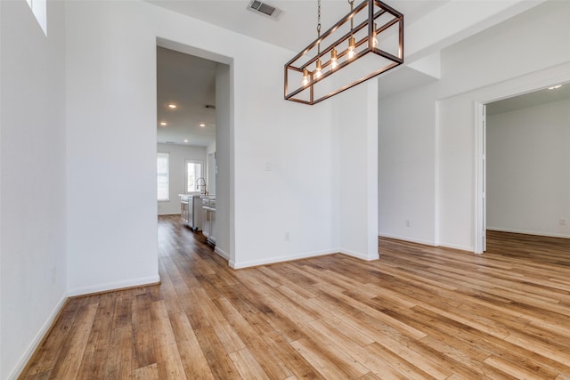 unfurnished dining area featuring light hardwood / wood-style floors and sink