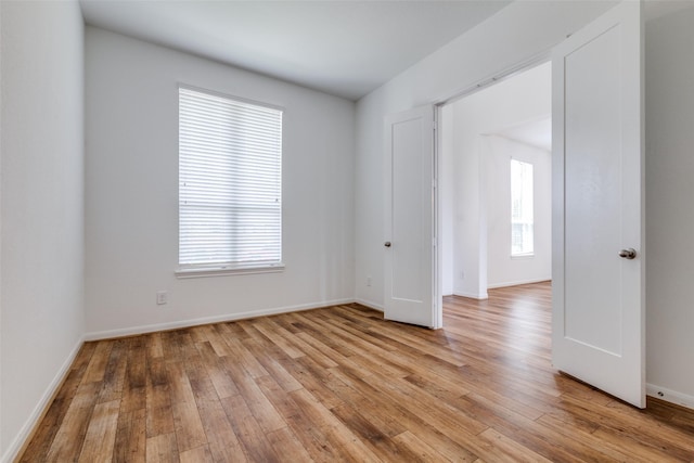 unfurnished room with a wealth of natural light and light hardwood / wood-style flooring