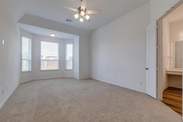 empty room with ceiling fan and light colored carpet