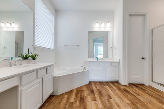 bathroom featuring vanity, wood-type flooring, and independent shower and bath