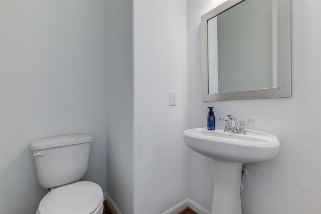 bathroom featuring toilet and sink