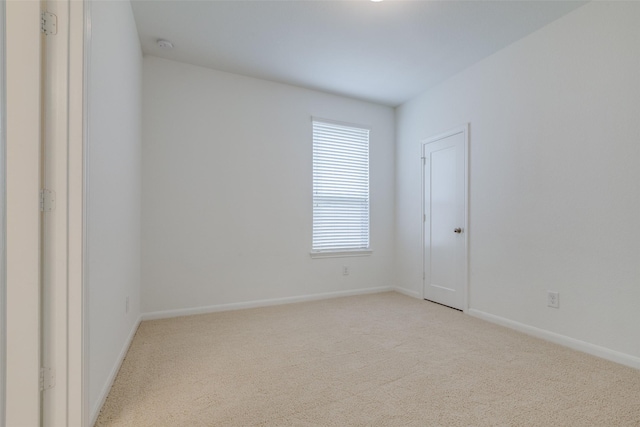 unfurnished room with light colored carpet