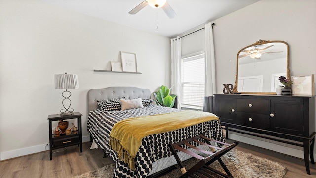 bedroom with hardwood / wood-style floors and ceiling fan