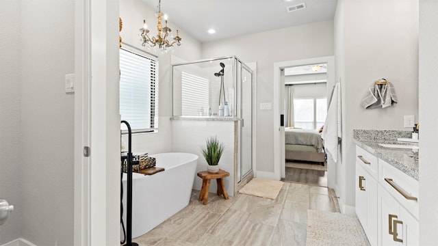 bathroom with plus walk in shower, vanity, and a chandelier