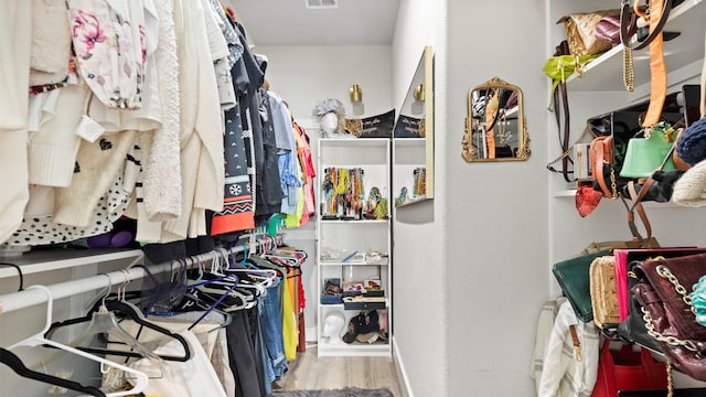 walk in closet featuring light hardwood / wood-style flooring