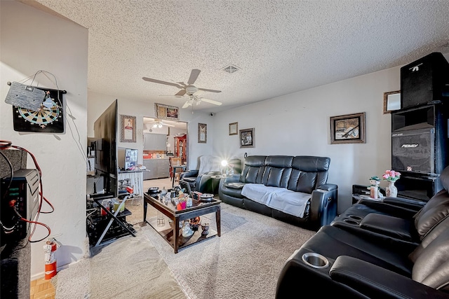 living room featuring ceiling fan and a textured ceiling