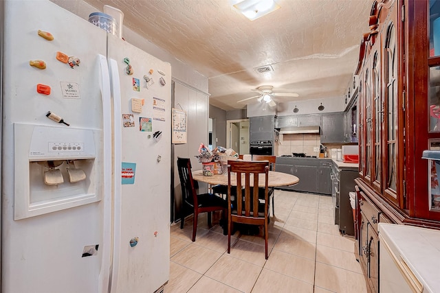 tiled dining space featuring ceiling fan