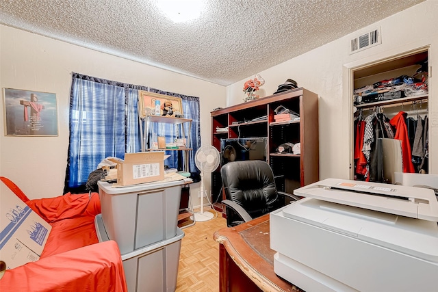 home office featuring a textured ceiling and light parquet floors