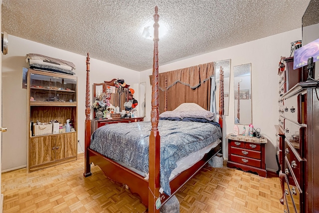 bedroom with a textured ceiling and light parquet floors