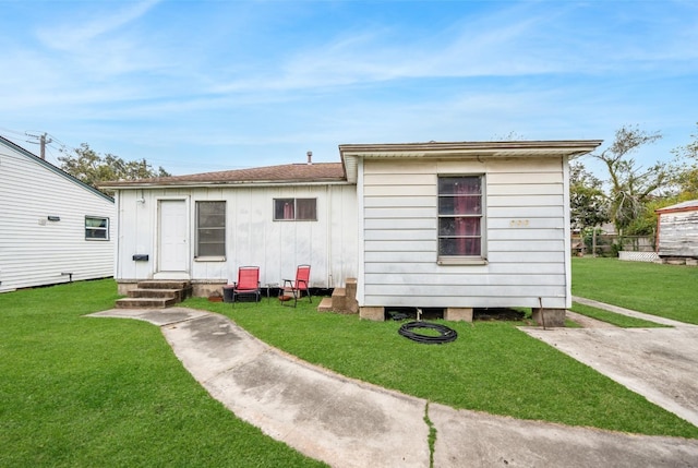 back of property featuring a yard