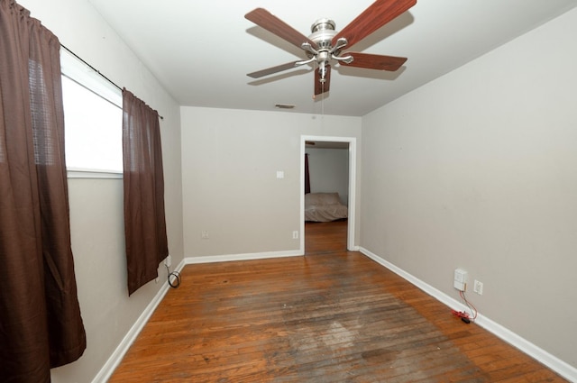 unfurnished room featuring dark hardwood / wood-style floors and ceiling fan