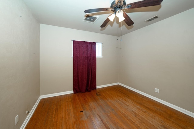 empty room with ceiling fan and hardwood / wood-style flooring