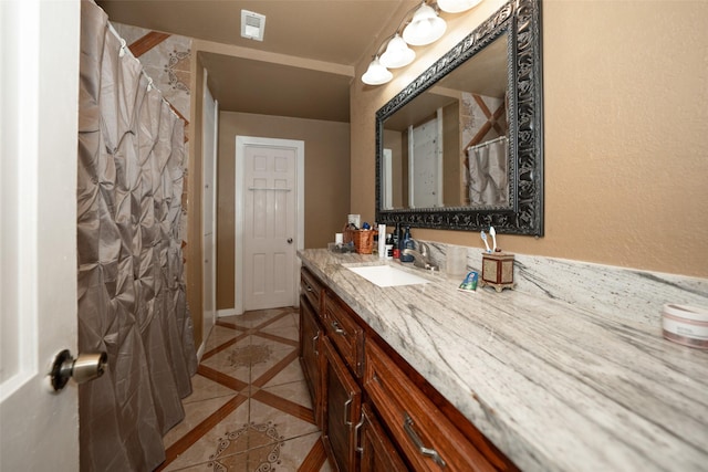 bathroom with tile patterned flooring and vanity