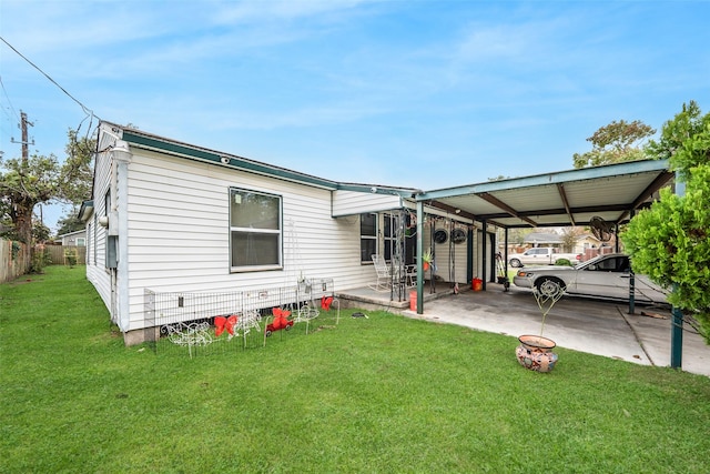 exterior space featuring a front lawn and a carport