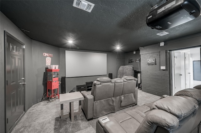 home theater room with light carpet, a textured ceiling, and visible vents