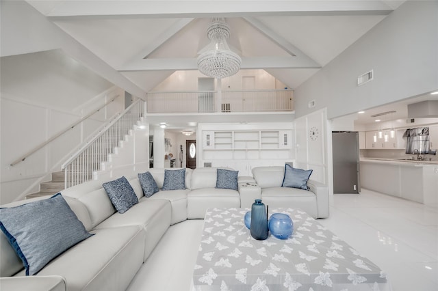 living area featuring high vaulted ceiling, stairs, visible vents, and light tile patterned floors