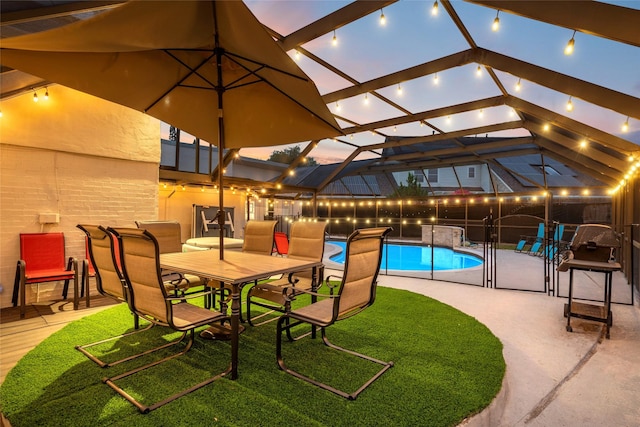 view of pool with glass enclosure, a fenced in pool, and a patio