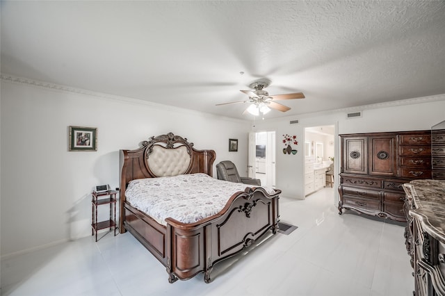 bedroom featuring a textured ceiling, ensuite bathroom, visible vents, a ceiling fan, and ornamental molding