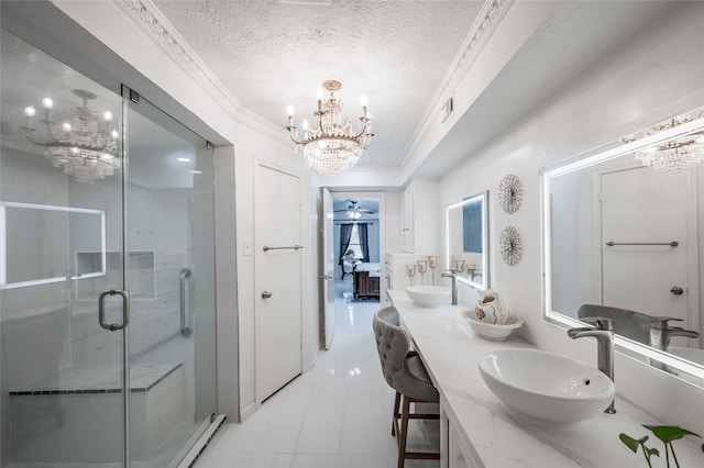 bathroom with vanity, tile patterned flooring, ornamental molding, a textured ceiling, and a shower with shower door