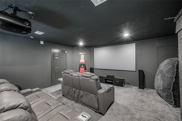 cinema featuring visible vents, a textured ceiling, and light colored carpet