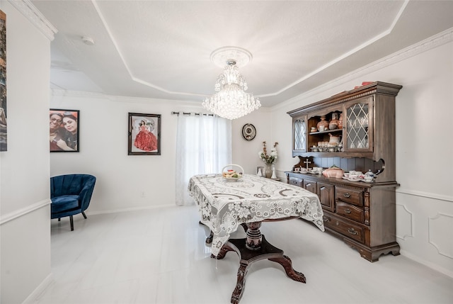 dining room featuring a notable chandelier, baseboards, and crown molding