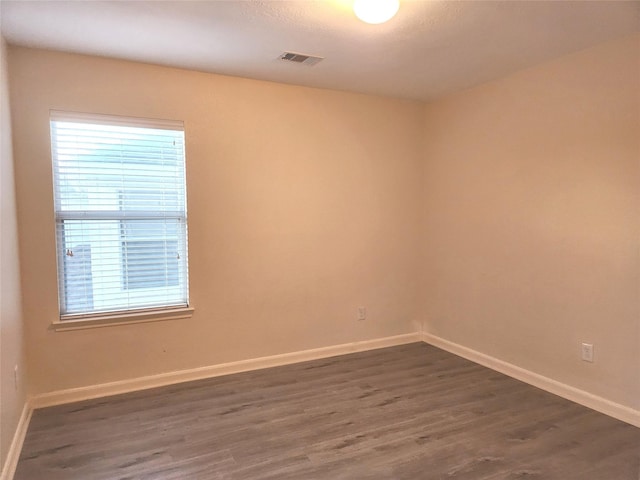 unfurnished room featuring dark hardwood / wood-style floors