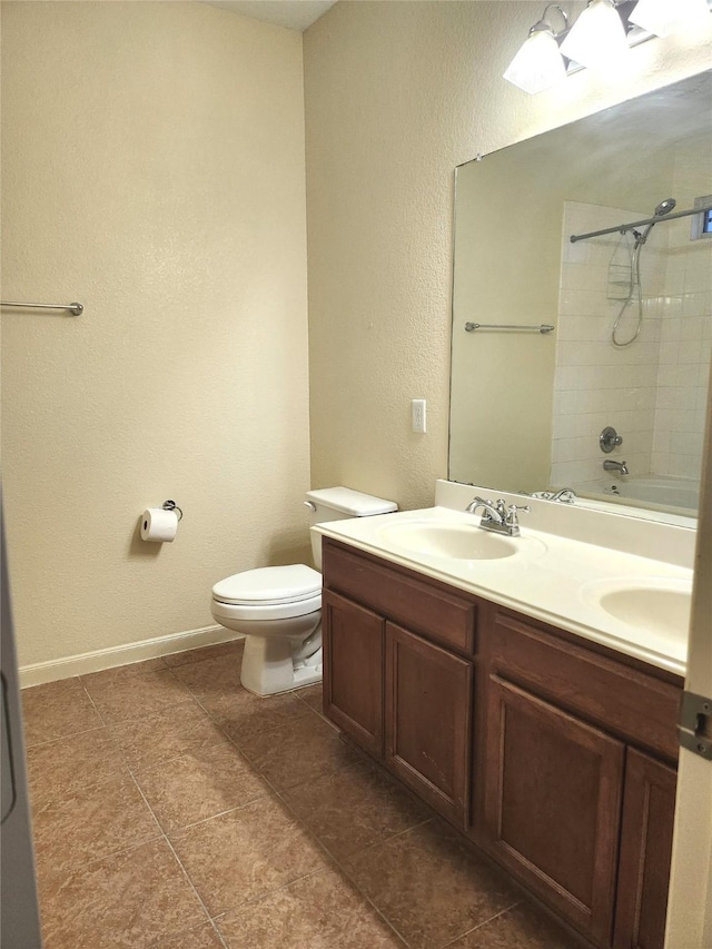 full bathroom with tile patterned floors, vanity, toilet, and tiled shower / bath