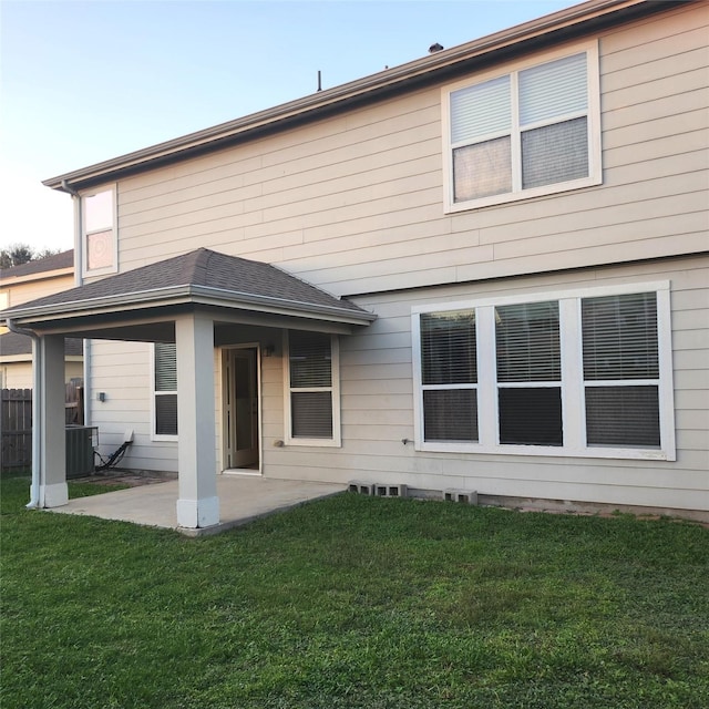 back of house with a lawn, cooling unit, and a patio