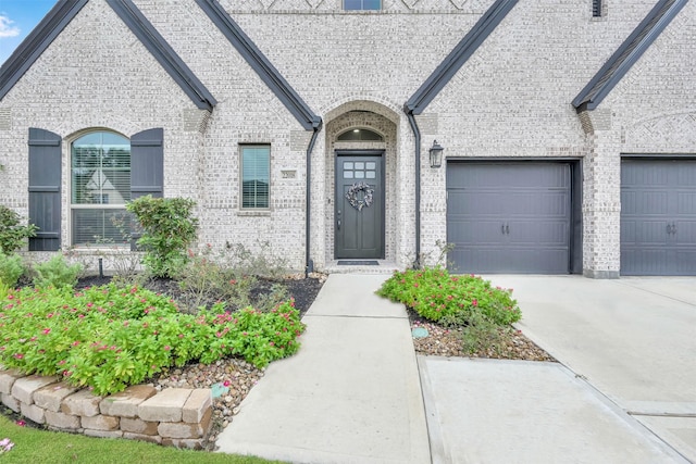 exterior space featuring concrete driveway, a garage, and brick siding