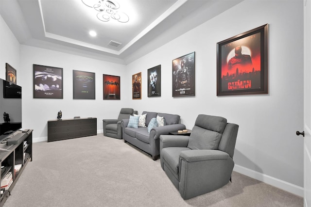 carpeted cinema featuring a raised ceiling