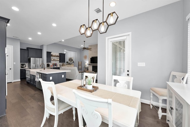 dining area featuring dark wood-type flooring and ceiling fan