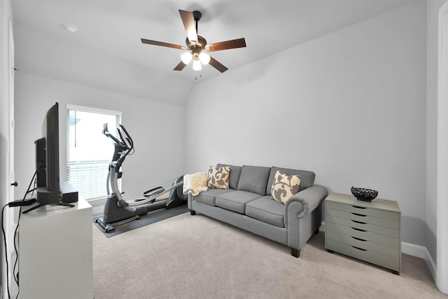 exercise area featuring ceiling fan, lofted ceiling, and light colored carpet