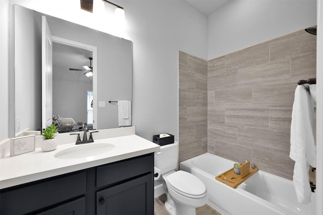 full bathroom featuring ceiling fan, toilet, vanity, and tiled shower / bath