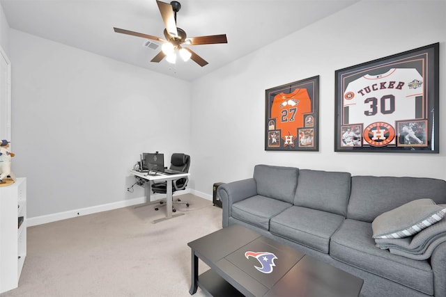 carpeted living room with ceiling fan