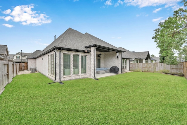 back of property featuring central air condition unit, a lawn, and a patio