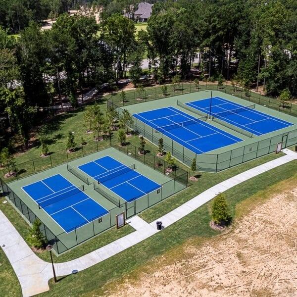 view of tennis court with a lawn