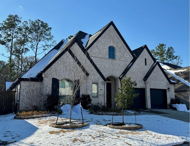 french country inspired facade featuring a garage