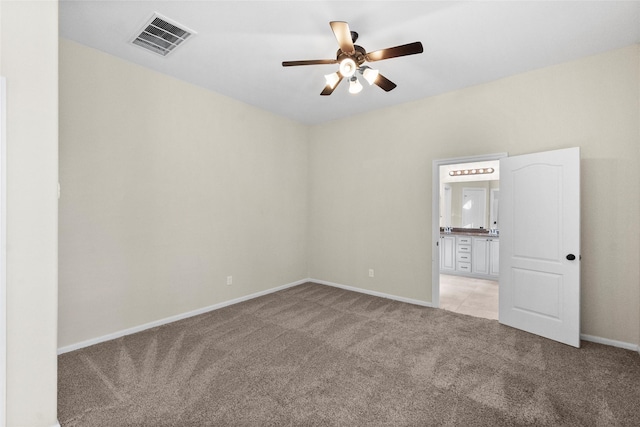 carpeted spare room featuring ceiling fan