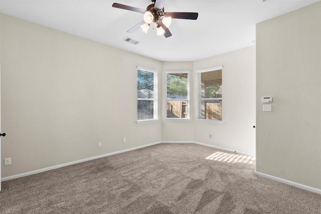 carpeted empty room featuring ceiling fan