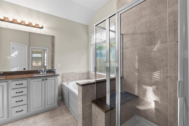 bathroom featuring tile patterned floors, vanity, independent shower and bath, and lofted ceiling