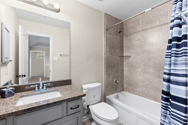 full bathroom featuring shower / bath combination with curtain, vanity, a textured ceiling, and toilet