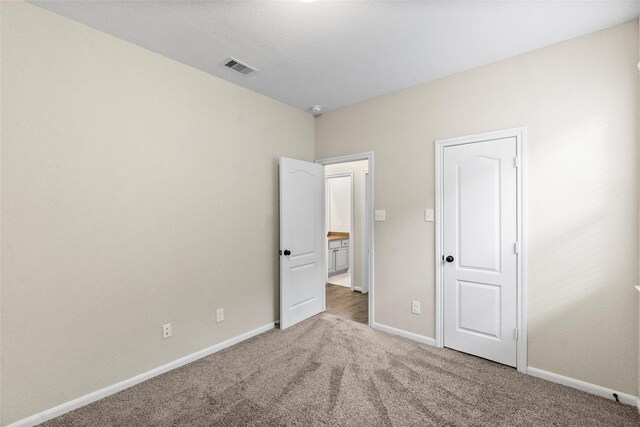 unfurnished bedroom with carpet