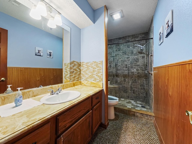 bathroom with tile patterned flooring, wood walls, toilet, and a textured ceiling