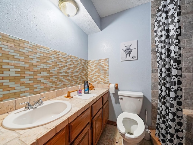 bathroom with vanity, backsplash, a shower with curtain, toilet, and a textured ceiling