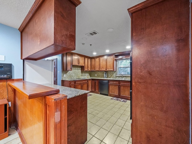 kitchen with kitchen peninsula, tasteful backsplash, a textured ceiling, black appliances, and light tile patterned floors