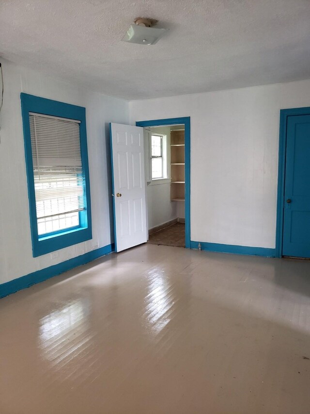 spare room with a textured ceiling