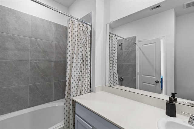 bathroom with shower / tub combo with curtain and vanity